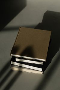 Kaboompics - Moody Reading Aesthetic with Hardcover Books and Window Shadows