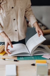 Kaboompics - Close-Up of Woman Turning Pages in Open Book