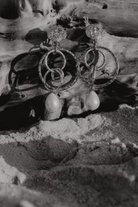 Kaboompics - Monochrome Pearl Drop Earrings on Weathered Driftwood