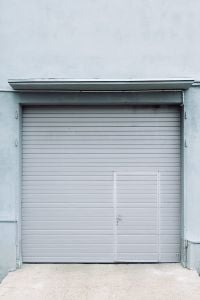 Kaboompics - Pale Blue Garage Door in a Weathered Wall