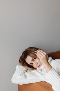 Kaboompics - Woman in White Sweater Wearing a Cross Necklace at Home