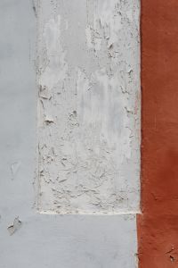 Kaboompics - Peeling White Paint on a Two-Tone Gray and Rust Wall, Weathered Surface Background