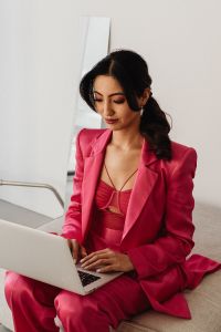 Kaboompics - Close Up Laptop Work in Pink Satin Suit