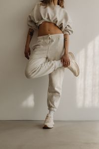 Kaboompics - Neutral Sportswear Stretching with One Leg Raised