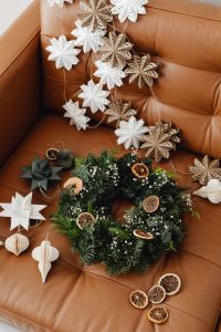 Kaboompics - Christmas Wreath with Paper Snowflake Garland on Sofa