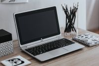 Kaboompics - Silver Laptop, Pencils and Graphic Design Notebook on a White Desk, Minimalist Workspace