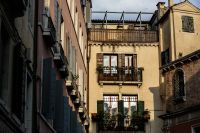Kaboompics - Quiet Venetian Courtyard with Balconies and a Warm Yellow Facade