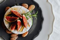 Kaboompics - Camembert with Figs and Almonds on Black Plate with Copy Space