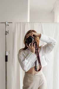 Kaboompics - Faceless Young Female Photographer Holding DSLR in Neutral Outfit