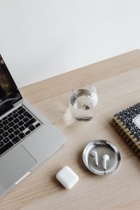 Kaboompics - Top View of Laptop, Glass of Water, AirPods and Notebook