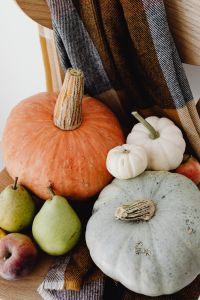 Kaboompics - Layered Orange, White and Gray Pumpkins with Pears on Plaid, Cozy Fall Decor