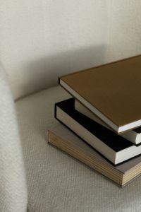 Kaboompics - Neutral Home Decor with Hardcover Books on Bouclé Chair