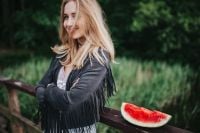 Kaboompics - Blonde woman having a healthy snack at the wooden pier