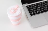 Kaboompics - Top-Down Pink Silicone Mug beside Laptop for a Modern Home Office