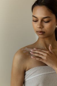Kaboompics - Woman Applying Cream to Shoulder