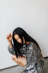 Kaboompics - Portrait of Black-Haired Woman in Silver Sequin Dress on White Background