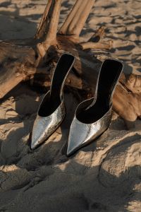 Kaboompics - Pair of Silver Heeled Mules on Driftwood and Beach Sand