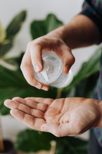 Kaboompics - Pump Bottle Dispensing Hand Sanitizer into Open Palm