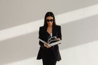 Kaboompics - Businesswoman in Sunglasses Reading a Magazine in a Minimalist Interior