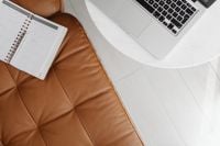 Kaboompics - Overhead Home Office Planning Scene with Open Laptop and Calendar on Tan Leather Sofa