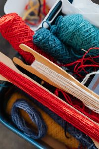 Kaboompics - Colorful Yarn Balls and Wooden Weaving Shuttle
