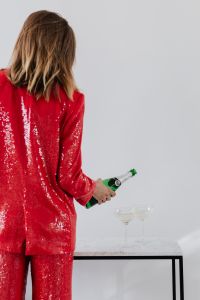 Kaboompics - Woman in Red Sequin Suit Preparing a Champagne Toast