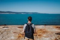Kaboompics - Backpacker Standing on a Rocky Shore Overlooking the Sea