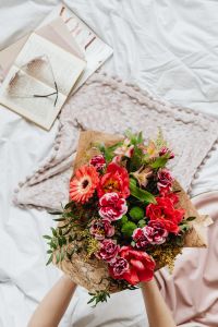 Kaboompics - Fresh Flower Bouquet on Bed Beside an Open Book