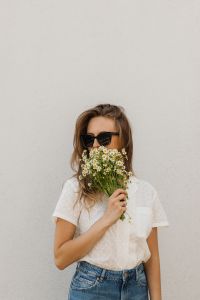 Kaboompics - Woman in Sunglasses Holding Daisies over Her Face