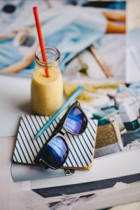 Healthy shake in a small bottle with a straw and sunglasses
