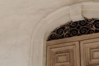 Kaboompics - Weathered Wooden Door with Arched Wrought Iron Fanlight