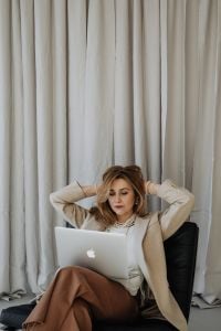 Kaboompics - Woman Resting Her Hands behind Her Head during Laptop Work