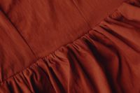 Kaboompics - Rust Red Fabric With Gathered Seam Detail