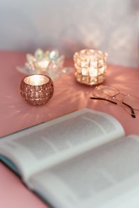 Kaboompics - Pink Reading Still Life with Open Book, Glasses and Gemstone Candle Holders