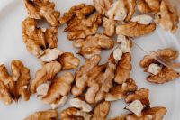 Kaboompics - Macro View of Walnut Halves Scattered across a White Surface