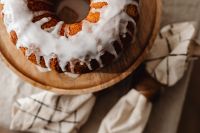 Kaboompics - Iced Bundt Cake with Christmas Greenery and Candle