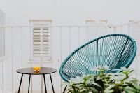 Kaboompics - A stylish garden chair and a small table on the balcony