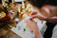Kaboompics - Hands Decorating a White Easter Egg with Colorful Beads