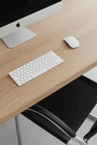 Kaboompics - Cropped iMac Desk Setup with White Keyboard and Mouse on Oak Wood