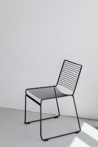 Kaboompics - Modern Black Wire Chair Framed By White Walls And Natural Light