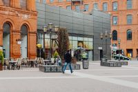 Kaboompics - Pedestrian Crossing the Manufaktura Plaza between Brick Buildings and Modern Glass Shops