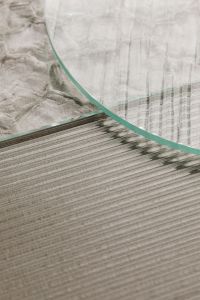Kaboompics - Tall Glass Panel with Sweeping Curved Edge over Ribbed Texture
