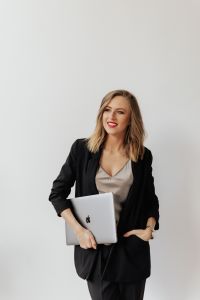 Kaboompics - Confident Businesswoman Posing with a Silver Laptop in a Bright Studio
