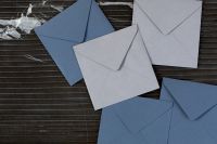 Kaboompics - Close-Up of Blue and White Envelopes on Dark Marble, Stationery Background