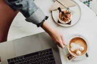 Kaboompics - Working with a laptop, meringue with whipped cream and coffee on white marble