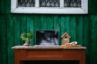 Kaboompics - Rustic Desk With Laptop, Houseplant and Birdhouse Decor