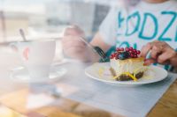 Kaboompics - Woman Enjoying Cheese Cake and a Coffee with Fruits in a Cafeteria