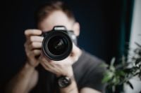 Kaboompics - Man Holding a DSLR Camera Directly Toward the Viewer