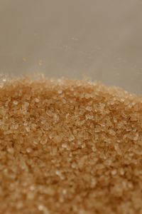 Kaboompics - Brown Sugar Crystal Pile on Neutral Beige Background with Copy Space