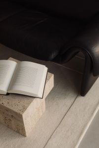 Kaboompics - Black Leather Sofa with Wine Glasses and Travertine Table
